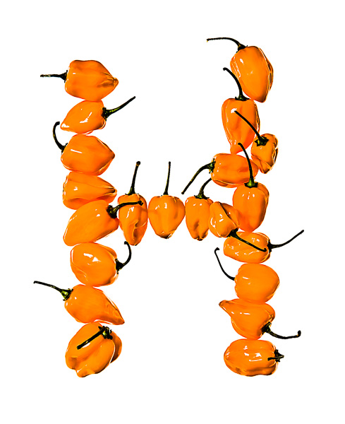 Photo of Habanero Peppers, laid out in the shape of the letter "H"