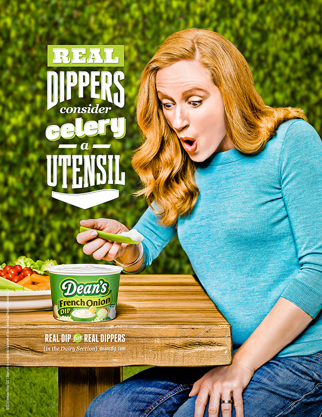 Photograph of woman using celery to scoop up large amounts of Dean's Dip