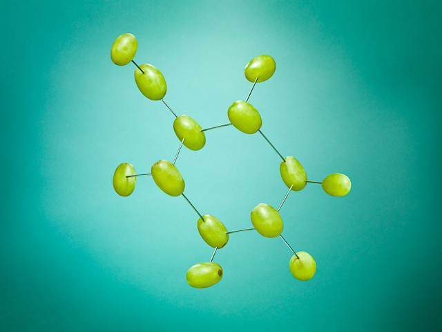 Photograph of grapes laid out to illustrate a molecular structure 